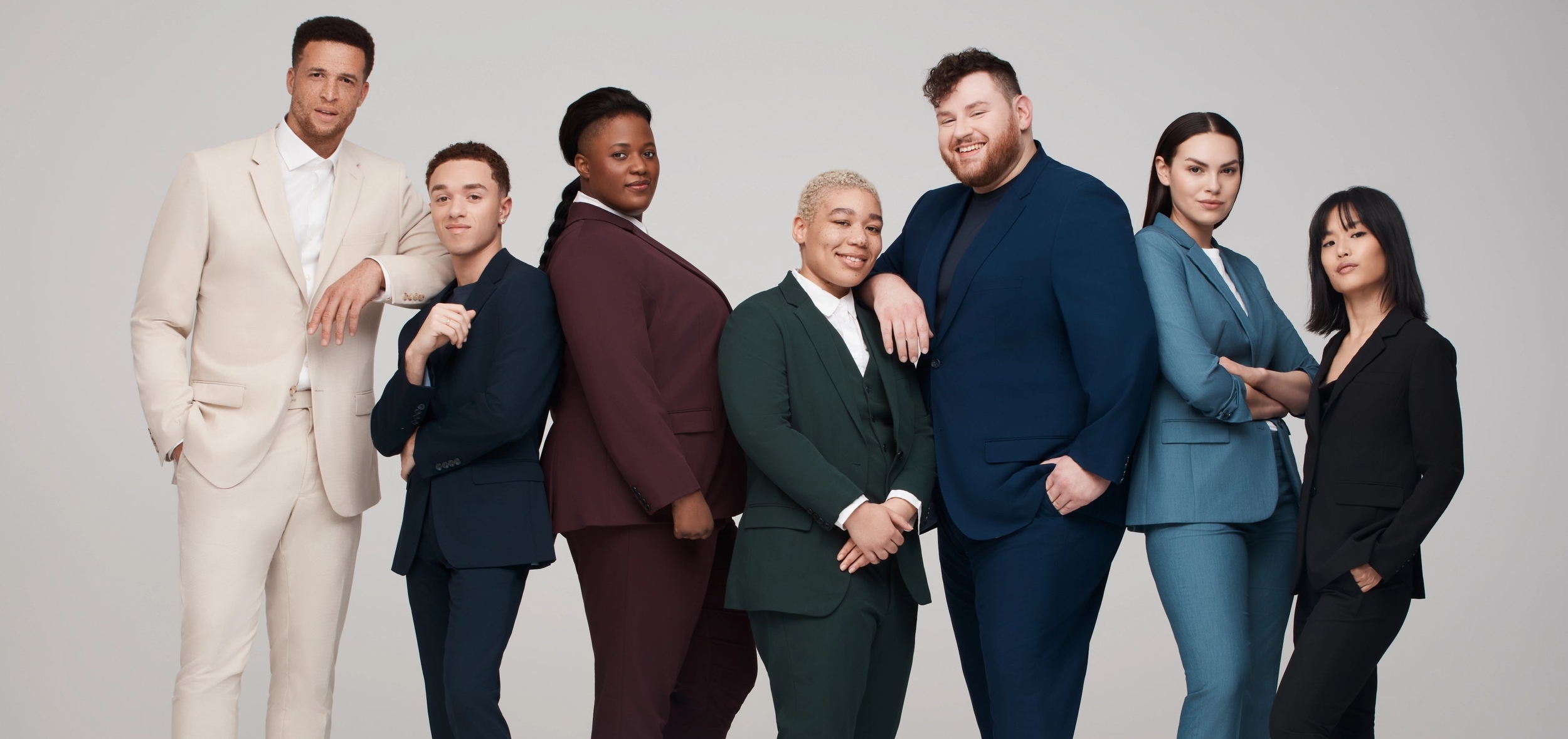 Diverse group of men, women, and nonbinary individuals in perfectly fitting suits for petite and plus sizes.